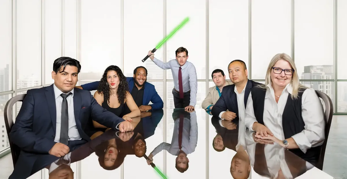 Diverse business team seated at conference table, one holding glowing sword